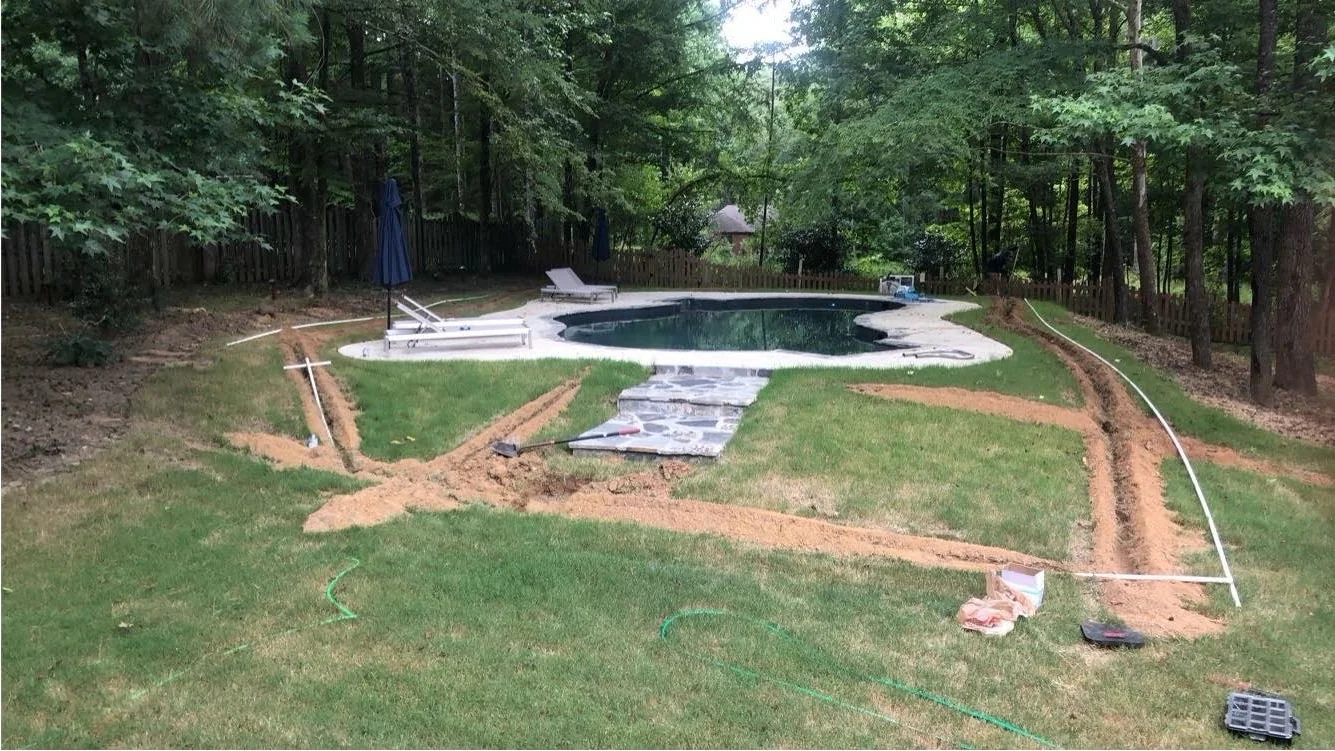 Irrigation install staged around a pool property in Oxford MS by Oxford Lawn Pro