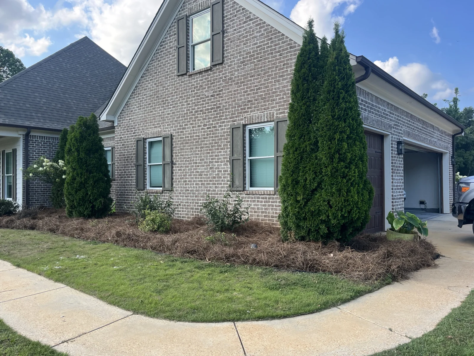 Fresh sod and landscaped beds along a brick home in Oxford MS